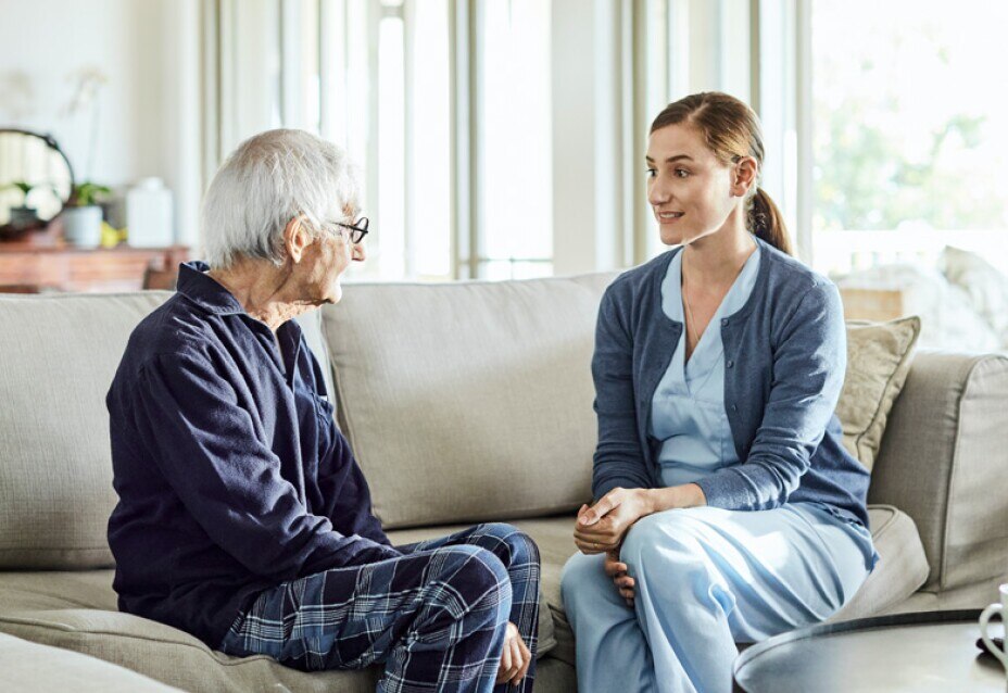 home nurse visiting with senior male patient