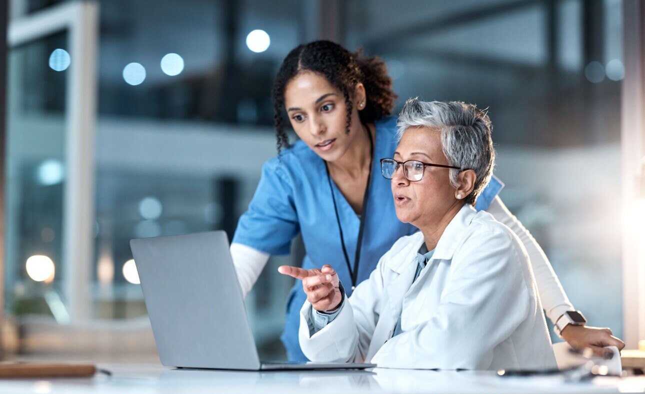doctor and nurse looking at computer