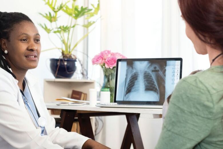 doctor showing patient x-ray images on the computer screen