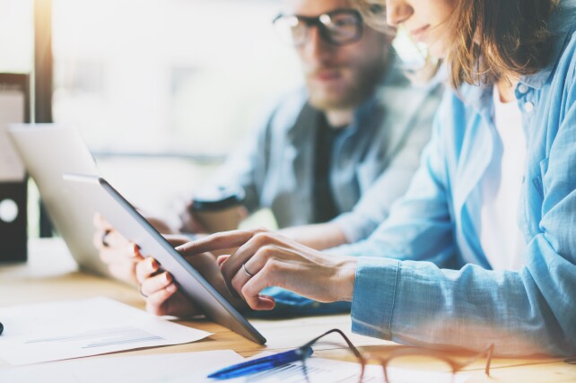 Man and Woman looking at tablet