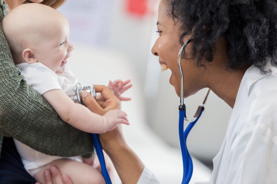 Female doctor listening to a baby's heartbeat with a stethoscope