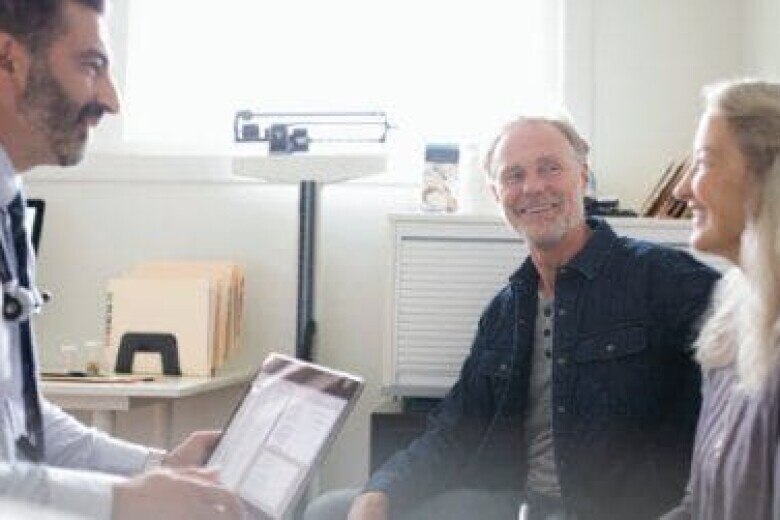 doctor having a conversation with a patient and her husband