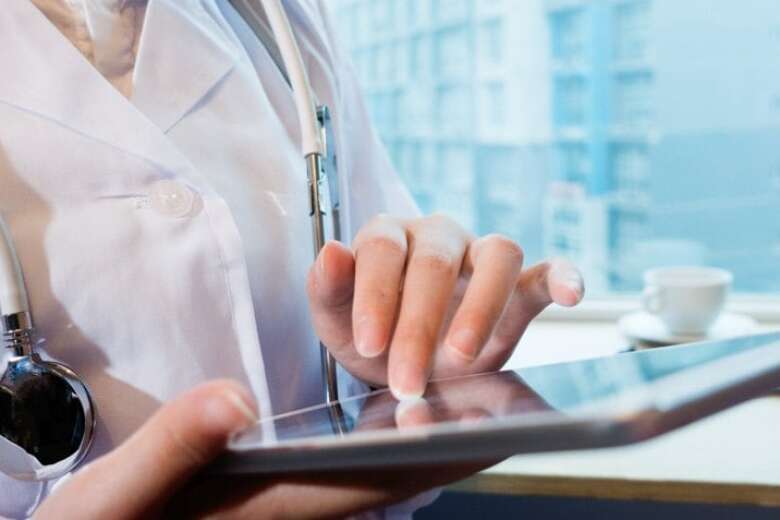 female doctor scrolling on a tablet