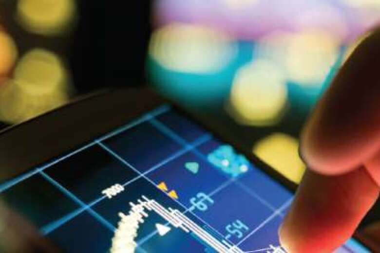 close up of fingers tapping a touch screen displaying data