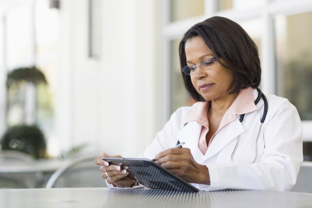 Senior female doctor using tablet PC
