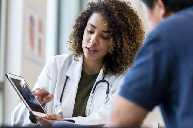 Physician pointing to tablet screen