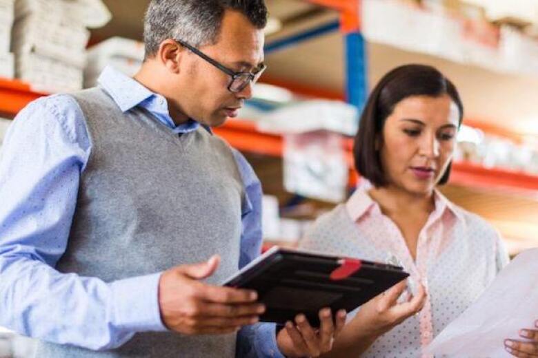 managers reviewing data in a warehouse