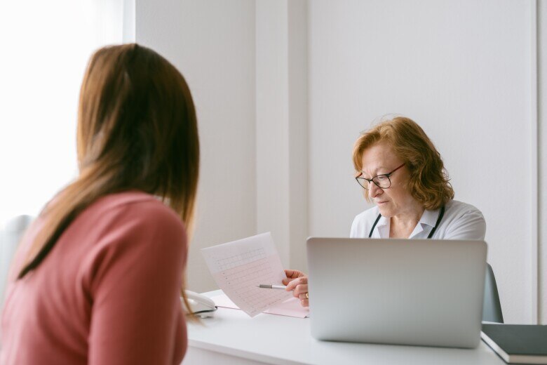 doctor showing an electrocardiogram to patient.