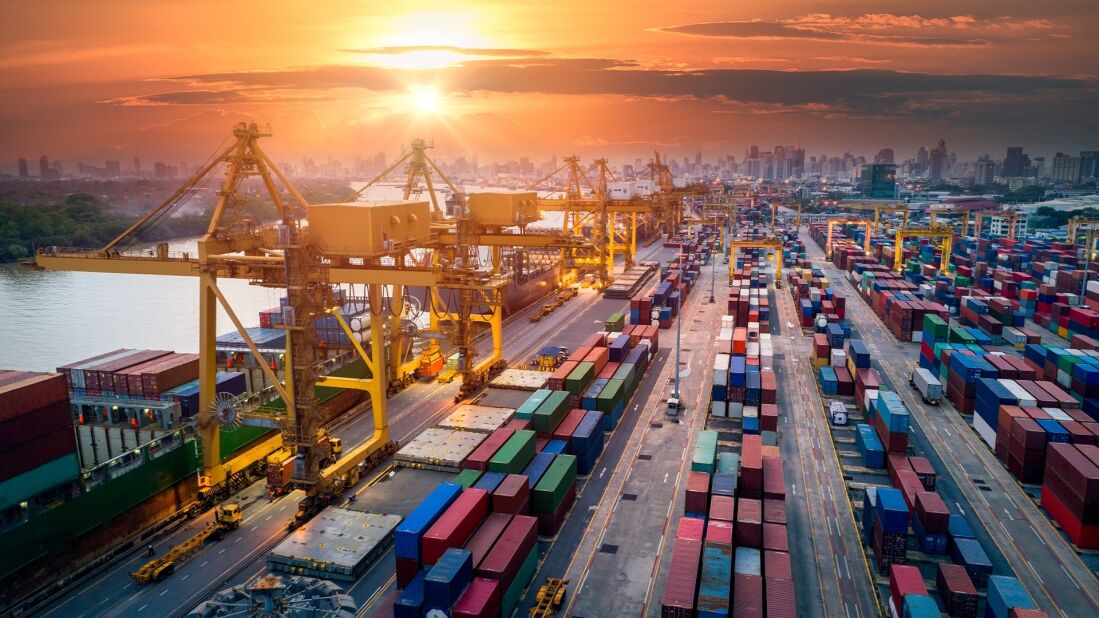 several rows of shipping containers waiting on a dock, ready to be loaded onto ships