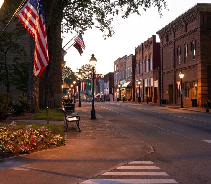 A main street in a small rural town just before dawn.