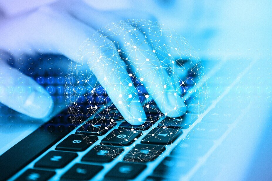 Healthcare information image showing a hand on a computer keyboard under a transparent sphere of data points