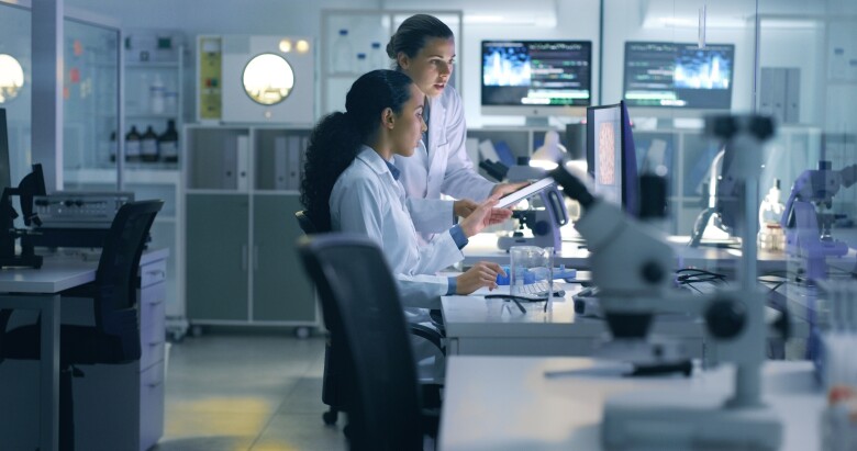 Two doctors reviewing computer in a clinical laboratory.