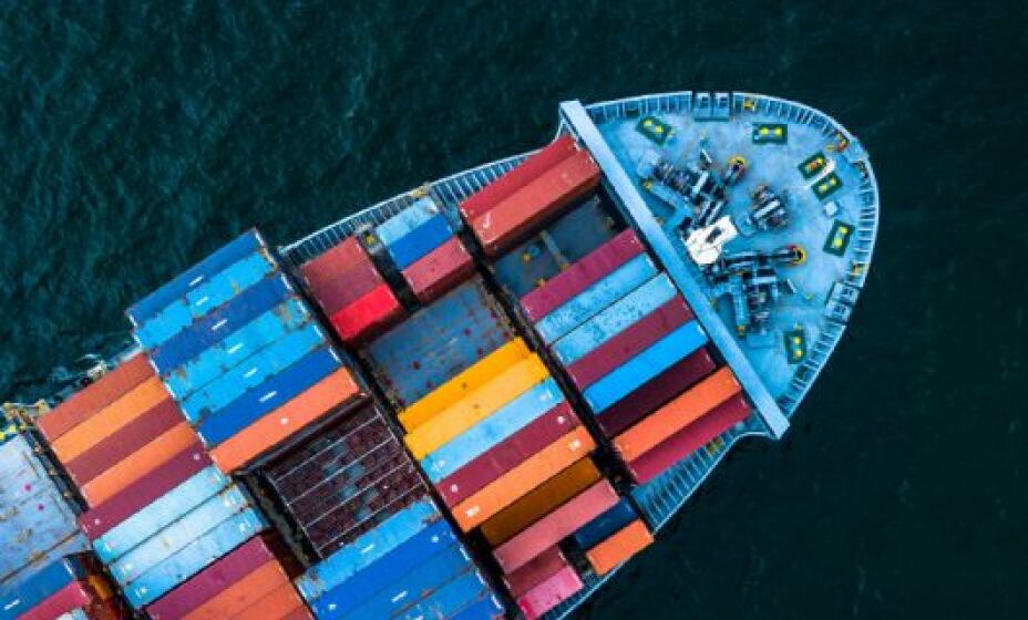 aerial view of a cargo ship loaded with colorful containers at sea
