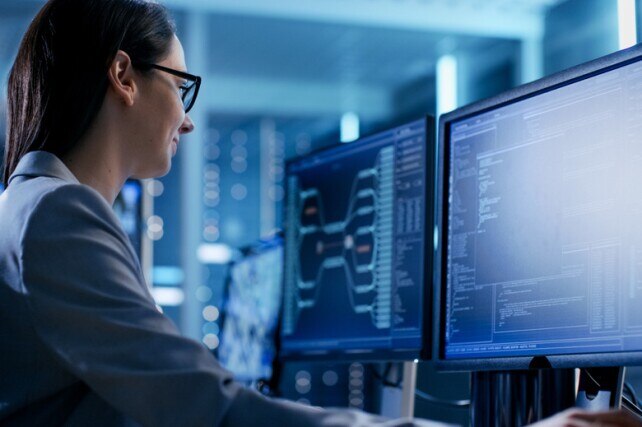 developer looking at code on a monitor