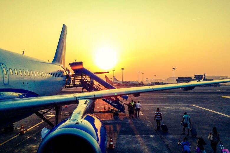 passengers boarding airplane from the tarmac