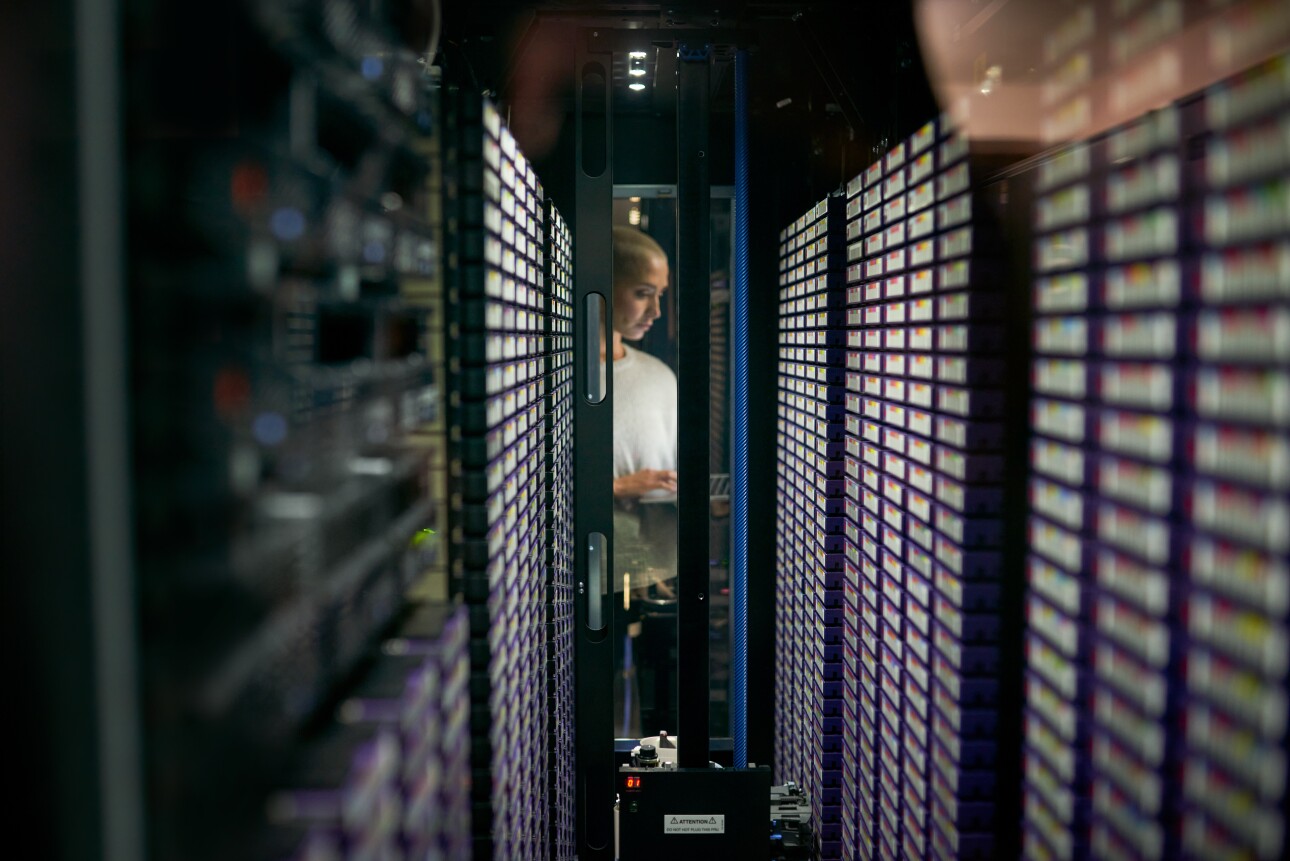 Shot of a young female engineer working in a server room