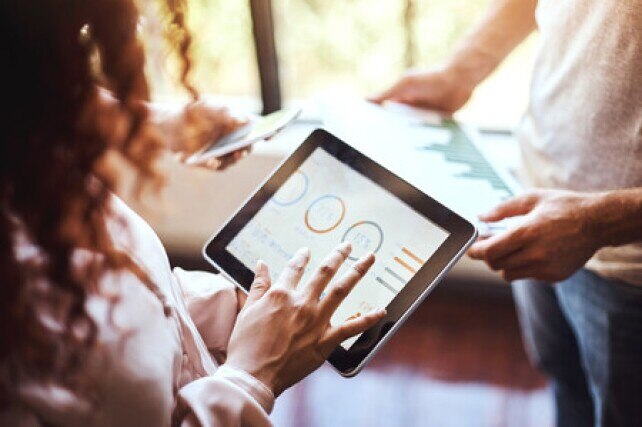 group of colleagues looking at various graphs on their devices