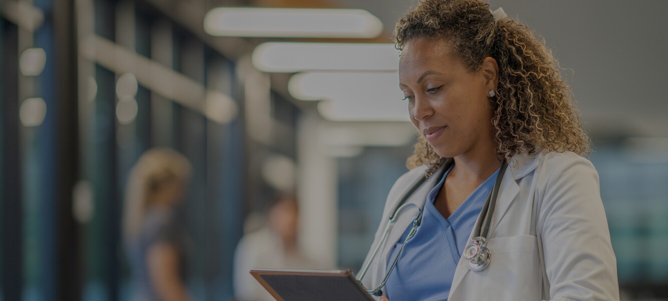 Black female doctor focusing on her tablet