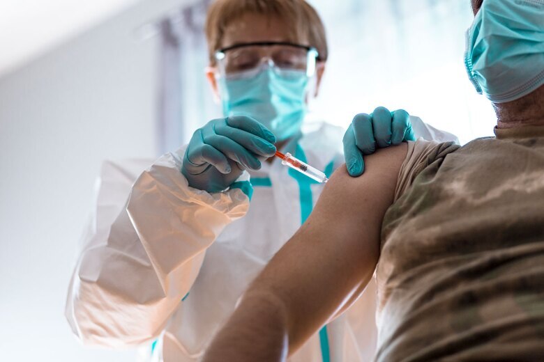 medical professional administering COVID vaccine