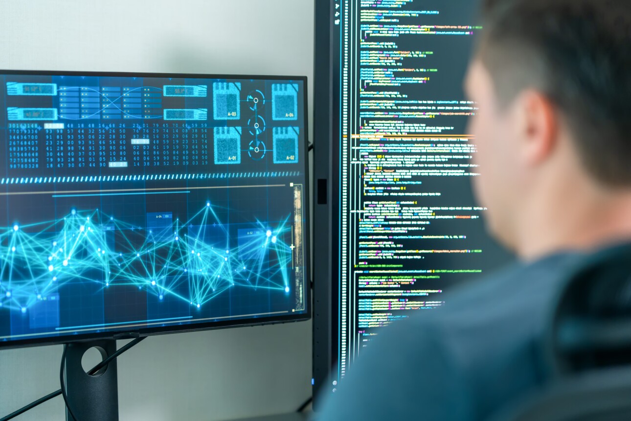 Software developers using computer to write code sitting at desk with multiple screens work remotely in home . Programmer development concept.