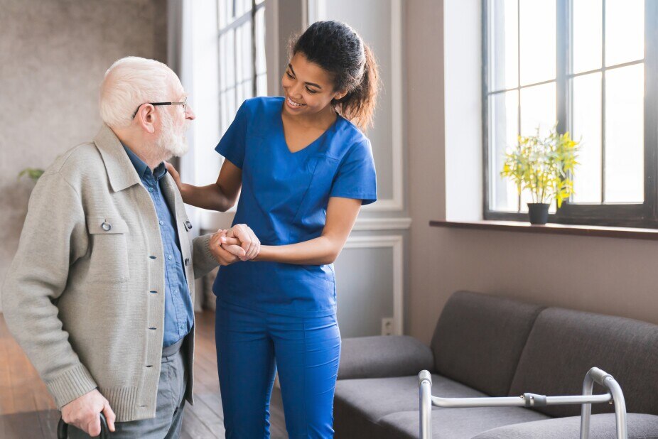 Young caring nurse with elderly man