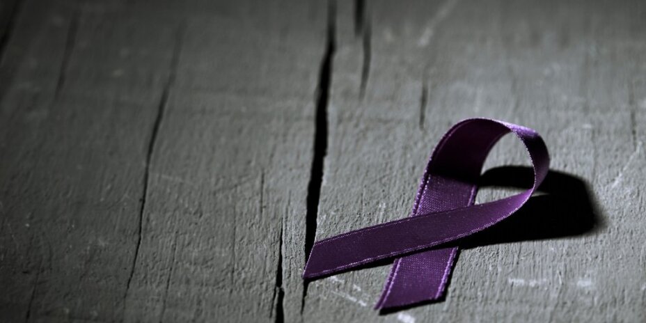 purple ribbon on a wood floor for Alzheimer's Awareness Month