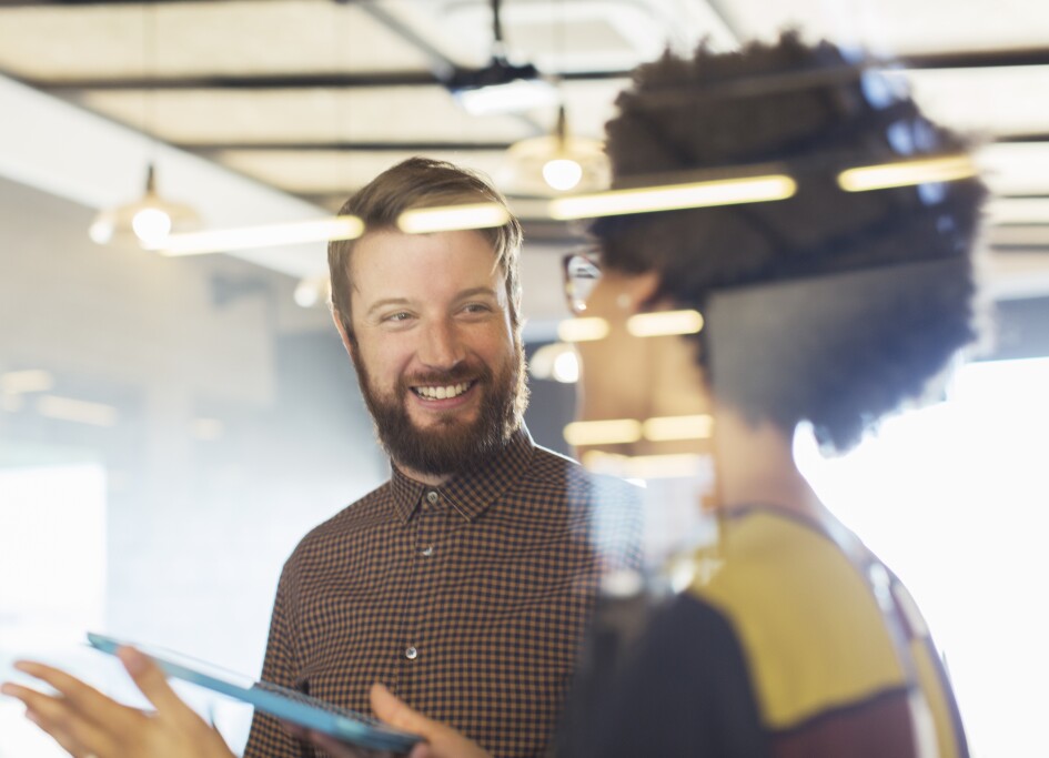 Business people using digital tablet in meeting