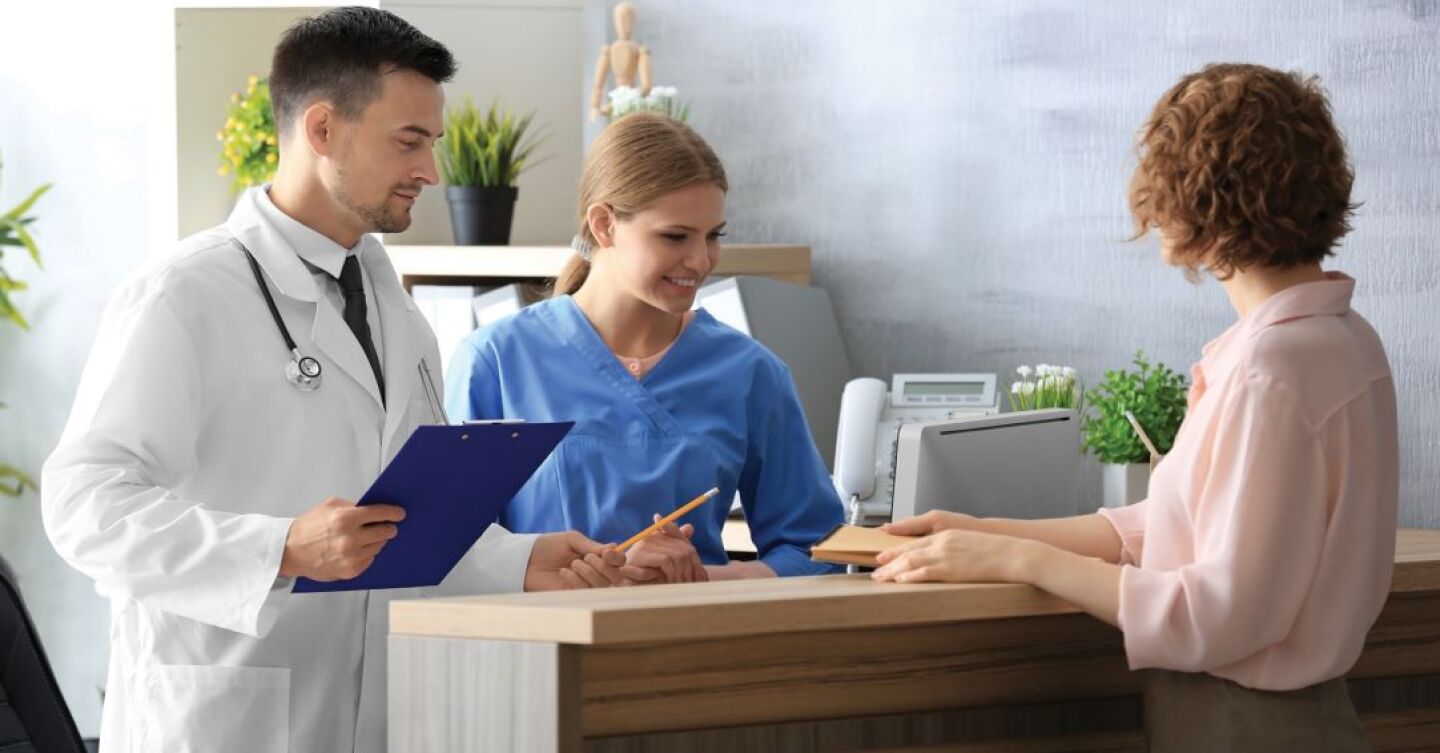 patient checking in at the reception desk in a doctor office, nurse doctor