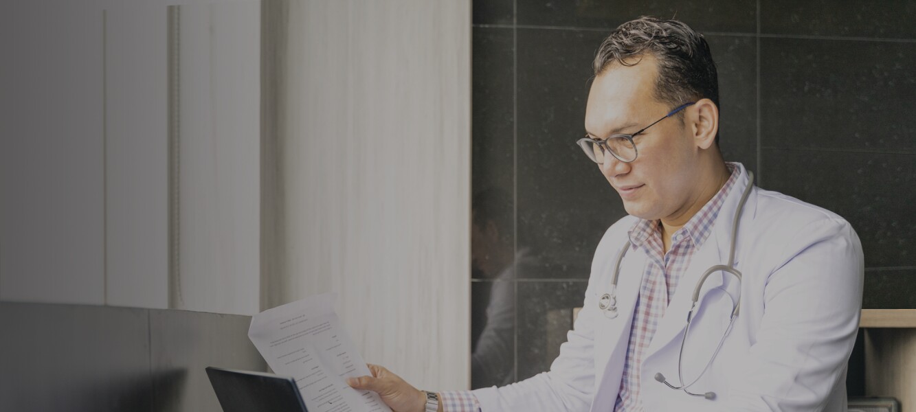 Indonesian doctor reviewing patient records