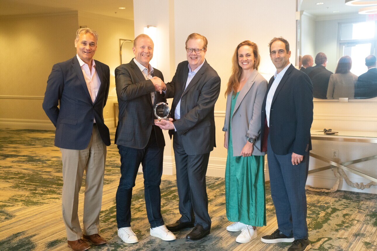 The NetSmart team accepts their Impact Award from InterSystems and Dr. Phil Budden from MIT