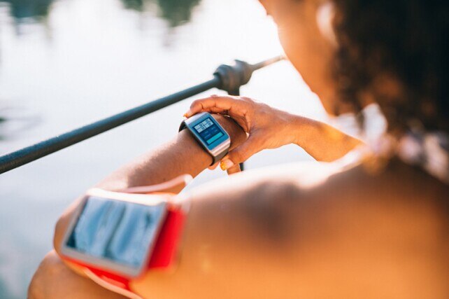 woman checking her smartwatch before her workout