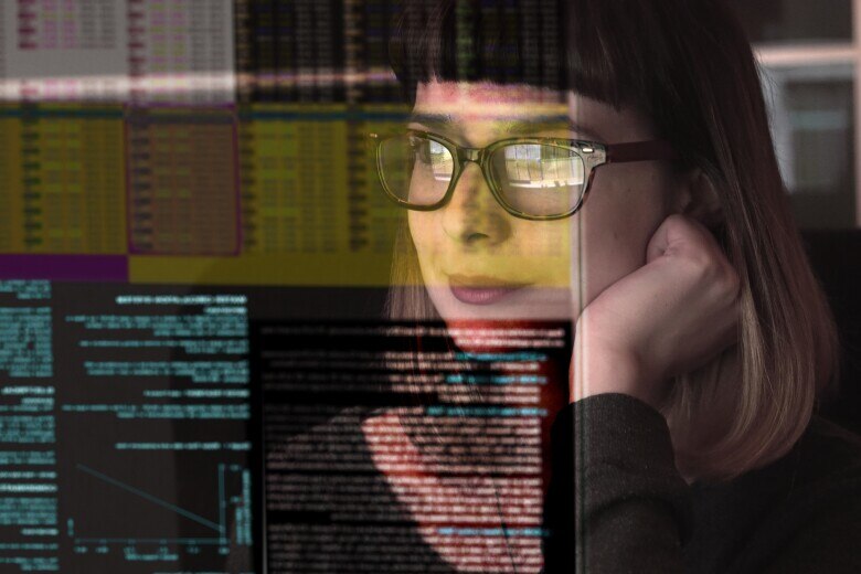 woman concentrating on a see through screen carrying a variety of data