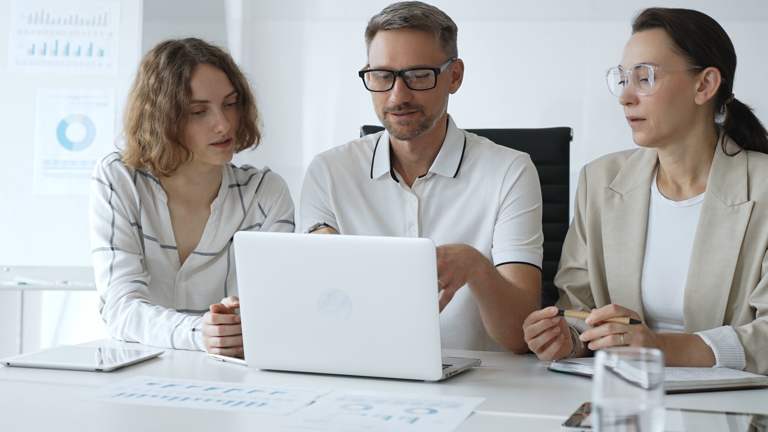 Professional Team Analyzing Data on Laptop in a business meeting