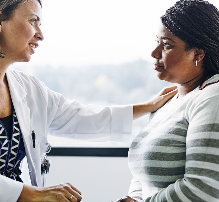 caring doctor comforts female patient