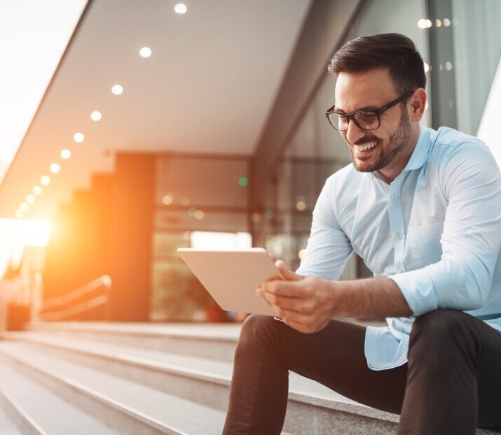 Business man looking at at tablet computer
