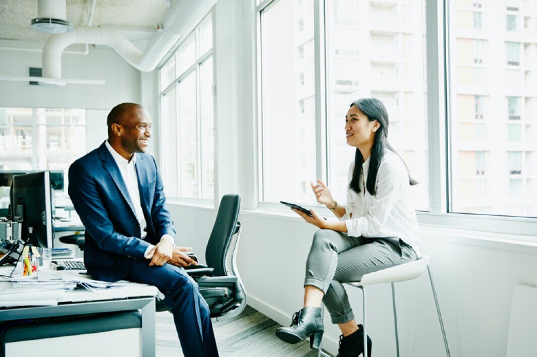 business colleagues having a friendly conversation in the office