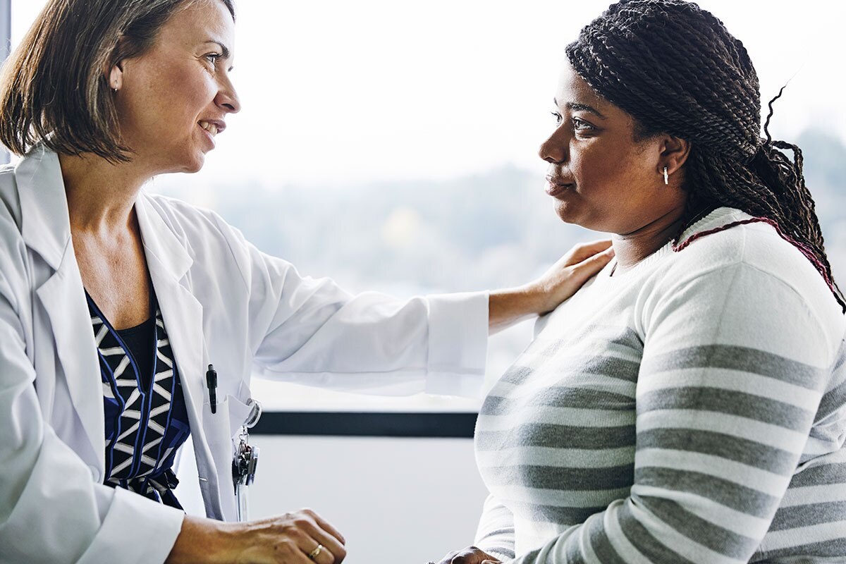 caring doctor comforts female patient