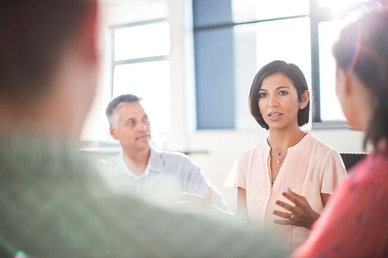 woman speaking during business meeting