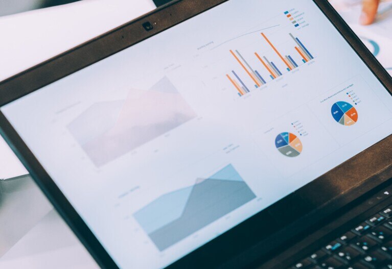 laptop screen with various graphs displayed on the screen