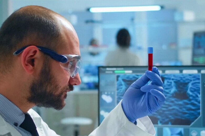 lab tech looking at vial