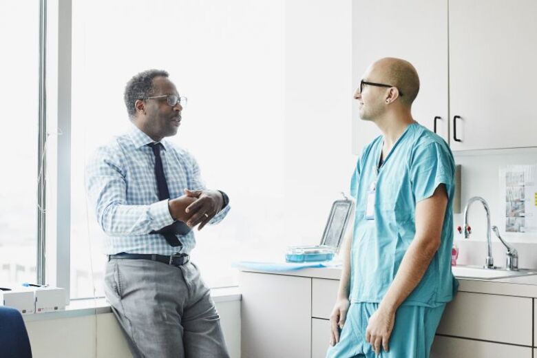 medical staff having a relaxed conversation in an exam room