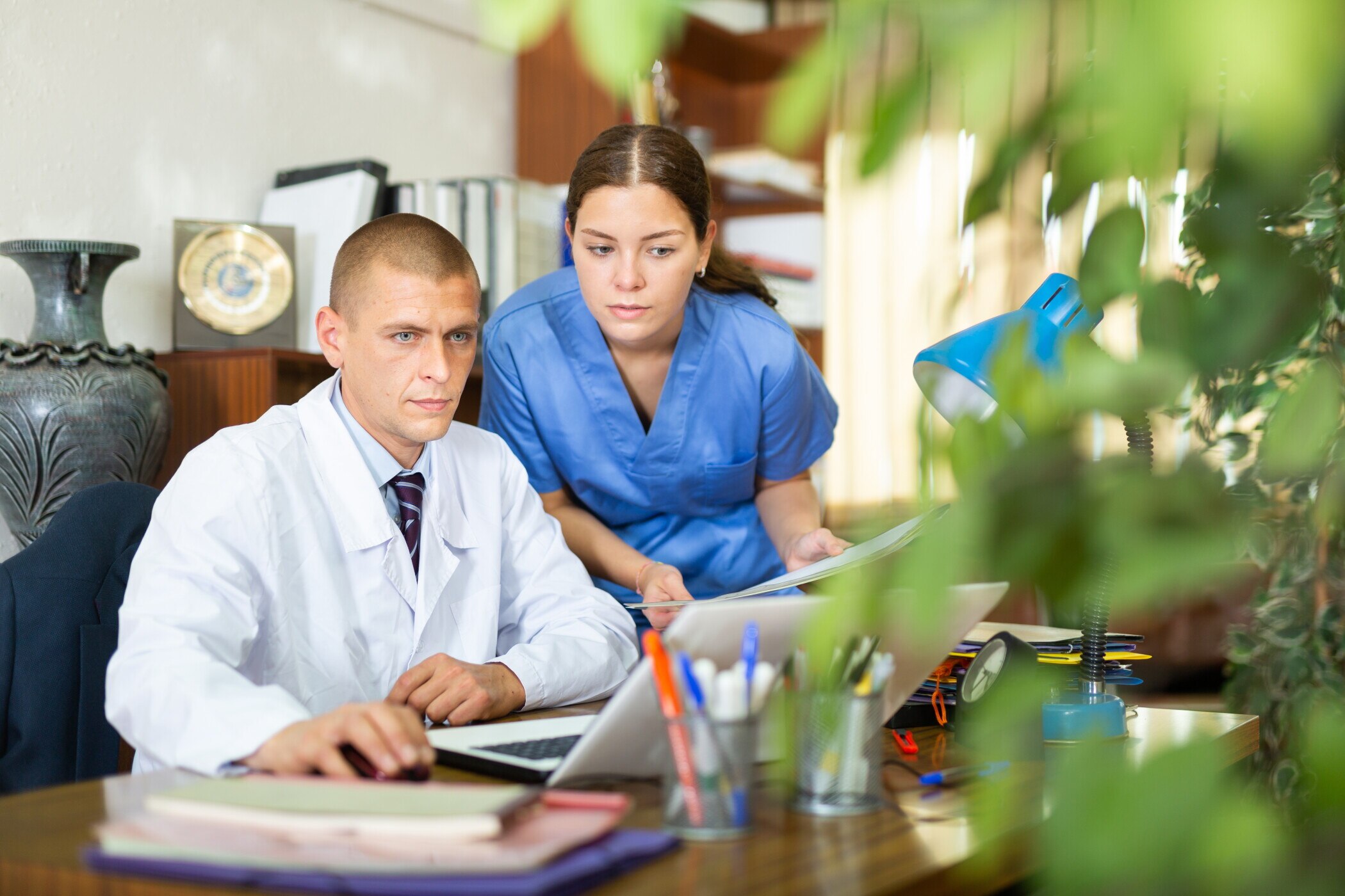Doctor and nurse at office at table