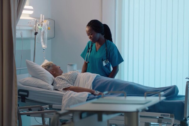 Doctor or Nurse at patient bedside