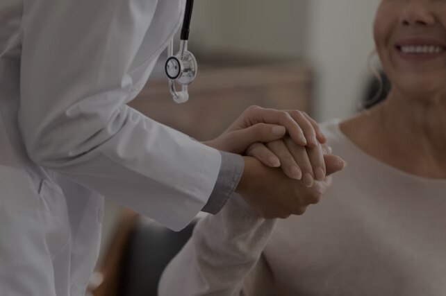 Female Physician Holding Patient's Hand