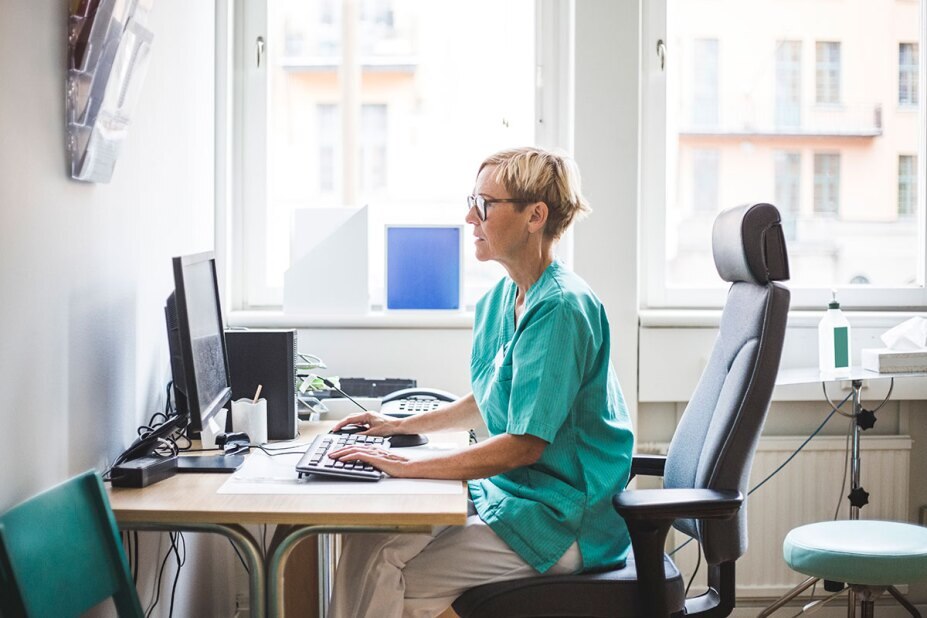 nurse working on a computer in her office