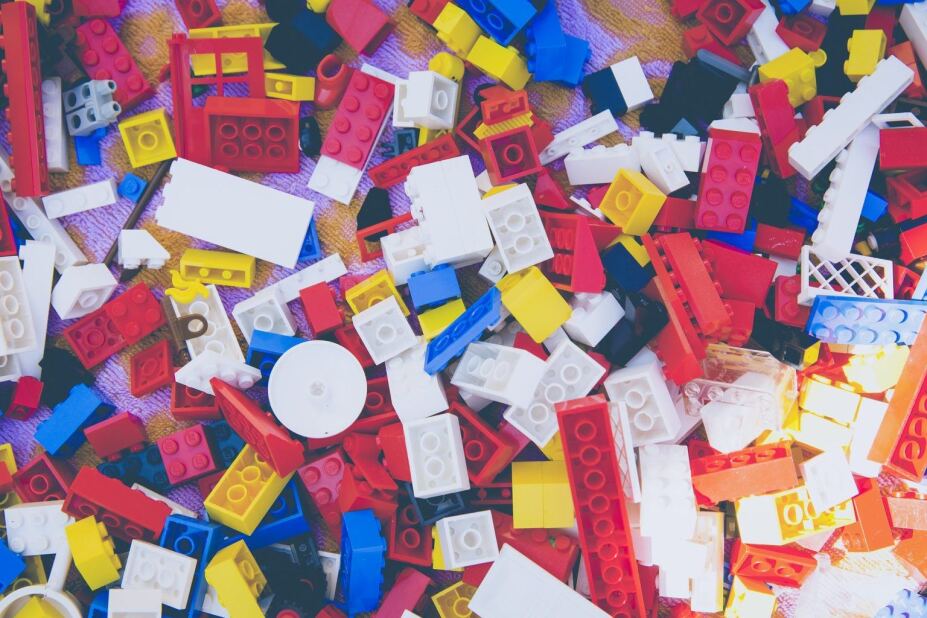 Pile of classic lego building blocks in red, blue, yellow, white and black