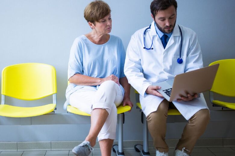 Doctor and patient seated in hallway