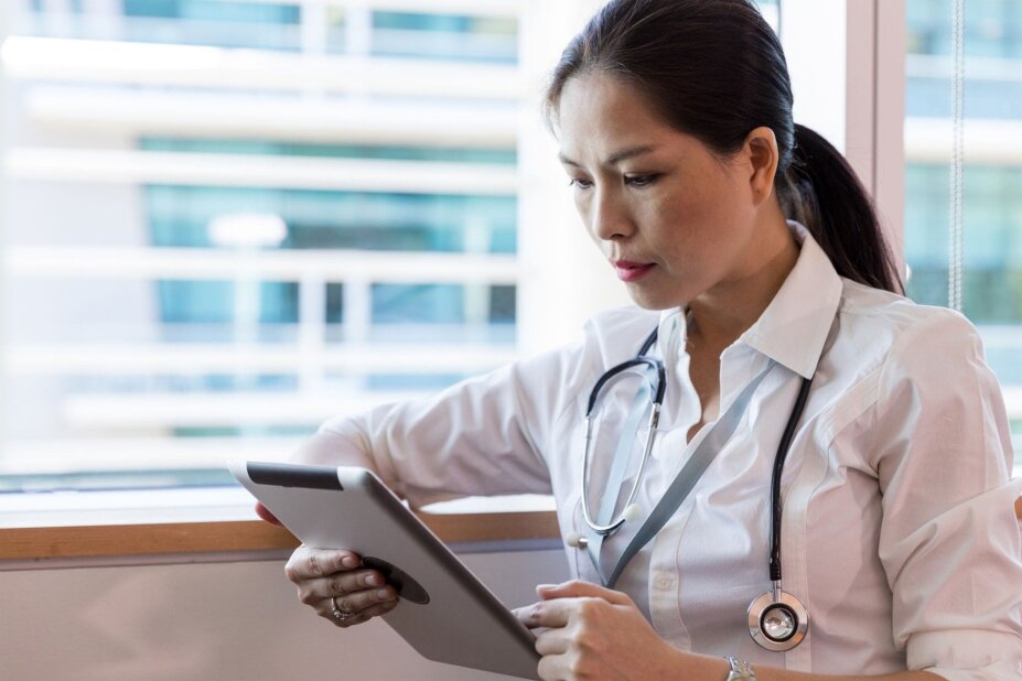 doctor reviews a patient's medical data on a tablet