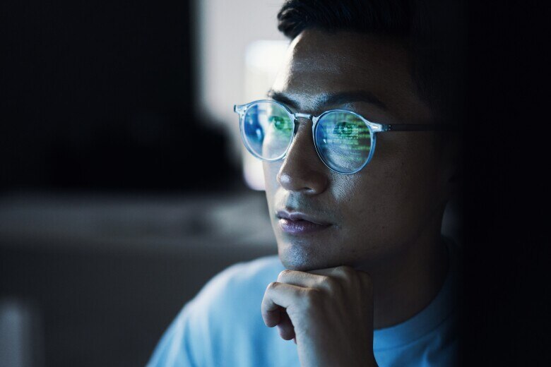 Asian man in glasses, focus and programming for cyber security, hacking and modern office, IT specialist coding, programming and thinking