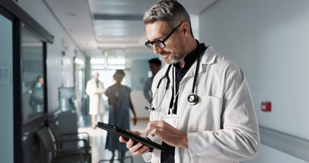 Doctor in hospital and tablet for medical information, typing and management of online charts or results.